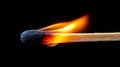 Close-up of a burning matchstick on a black background. Royalty Free Stock Photo