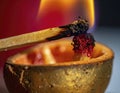 Closeup of a burning matchstick igniting a rustic candle wick in a warm intimate setting Royalty Free Stock Photo