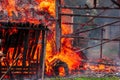 Close-up of a burst of fire coming from a burning barn. Royalty Free Stock Photo