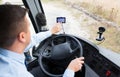 Close up of bus driver driving with gps navigator Royalty Free Stock Photo