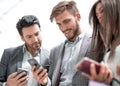 Close up.business colleagues reading a text on smartphones Royalty Free Stock Photo