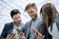 Close up.business colleagues reading a text on smartphones Royalty Free Stock Photo