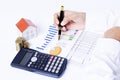 close up of business fountain pen on chart with house paper, coins stack and calculator for Mortgage loans concept Royalty Free Stock Photo