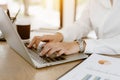 Close up business hands typing on laptop keyboard. Business hands surfing the internet