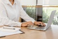 Close up business hands typing on laptop keyboard. Business hands surfing the internet in office