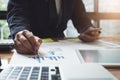 Close-up of business man hand with pen pointing at paper while e Royalty Free Stock Photo