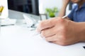 Male hand holding silver pen ready to make note in paper sheet. Royalty Free Stock Photo