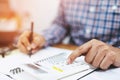 Close up business man hand is writing in a notebook and using calculator counting making notes Accounting at doing finance at offi Royalty Free Stock Photo