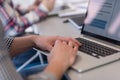 close up of business man hands typing on laptop with team on meeting in background Royalty Free Stock Photo