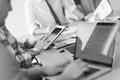 close up of business man hands typing on laptop with team on meeting in background Royalty Free Stock Photo