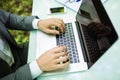 Close up business man at laptop at office table hands in green forest park. Business concept. Royalty Free Stock Photo