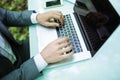 Close up business man at laptop at office table hands in green forest park. Business concept. Royalty Free Stock Photo