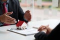 Close up of Business man pointing and signing agreement for buying house. Bank manager concept. Royalty Free Stock Photo