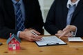 Close up of Business man pointing and signing agreement for buying house. Bank manager and real estate concept. Royalty Free Stock Photo