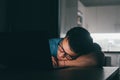 Close up business man put head on folded hands sleeping at workplace at night. Overloaded office employee tired of routine Royalty Free Stock Photo