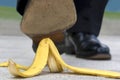 Close up business man stepping on banana skin Royalty Free Stock Photo