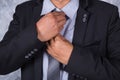 Close up business man in suit fixing his tie Royalty Free Stock Photo