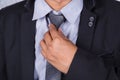 Close up business man in suit fixing his tie Royalty Free Stock Photo