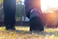 Close up business man walking on grass in public park. He is wearing black shoe and step up in to grass in a yard. Royalty Free Stock Photo