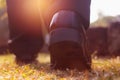 Close up business man walking on grass in public park. He is wearing black shoe and step up in to grass in a yard. Royalty Free Stock Photo