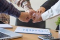 Close-up of business partners making pile of hands at meeting,Team work