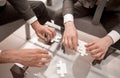 Close up.business partners putting together a puzzle ,sitting at office Desk Royalty Free Stock Photo