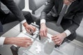 Close up.business partners putting together a puzzle ,sitting at office Desk Royalty Free Stock Photo