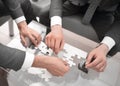 Close up.business partners putting together a puzzle ,sitting at office Desk Royalty Free Stock Photo