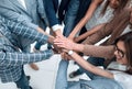 Close up.Business people holding hands in a circle