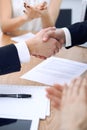 Close up of business people shaking hands at meeting or negotiation in the office. Partners are satisfied because Royalty Free Stock Photo