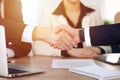 Close up of business people shaking hands at meeting or negotiation in the office. Partners are satisfied because Royalty Free Stock Photo