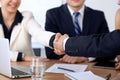 Close up of business people shaking hands at meeting or negotiation in the office. Partners are satisfied because Royalty Free Stock Photo