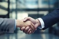 Close up of business people shaking hands in office. Handshake concept, handshaking close up, to businessman shaking hand close up
