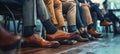 Close up of business peoples legs waiting for a job interview. Hiring and recruitment concept