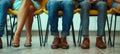 Close up of business peoples legs waiting for a job interview. Hiring and recruitment concept