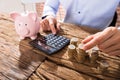 Person Counting Coins Using Calculator Royalty Free Stock Photo