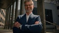 Close up business portrait outdoors in city middle-aged Caucasian man businessman toothy smiling at camera office