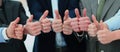 Cheering business people holding many thumbs thumbs up Royalty Free Stock Photo