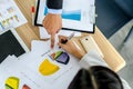 Close-up of business team image of male hand pointing at business document during discussion at meeting and using pen with Royalty Free Stock Photo