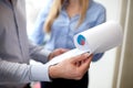 Close up of business team looking at clipboard