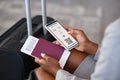 Close up of business woman checking flight e-ticket on phone at airport