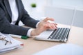 Close-up of business woman hands typing on laptop computer in the white colored office. Royalty Free Stock Photo