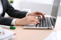 Close up of business woman hands typing on laptop computer in the white colored office. Royalty Free Stock Photo