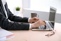 Close up of business woman hands typing on laptop computer in the white colored office. Royalty Free Stock Photo