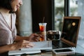 Close up of business woman`s hands using laptop and writing in her calendar notepad Royalty Free Stock Photo