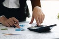 Close up Business woman using calculator for do math finance on wooden desk in office and business working background, tax, Royalty Free Stock Photo