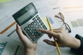 Close up Business woman using calculator for do math finance on wooden desk in office and business working background, tax, Royalty Free Stock Photo