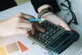 Close up Business woman using calculator for do math finance on wooden desk in office and business working background, tax, Royalty Free Stock Photo