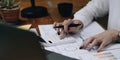 Close up Business woman using calculator and laptop for do math finance on wooden desk in office and business working background, Royalty Free Stock Photo