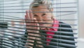 close up. a business woman looks through the window blinds. Royalty Free Stock Photo